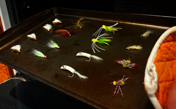 Flies displayed include: chubby chernobyl, clouser minnow, barr's meat whistle, popper, crazy charlie, and turneffe crab 
